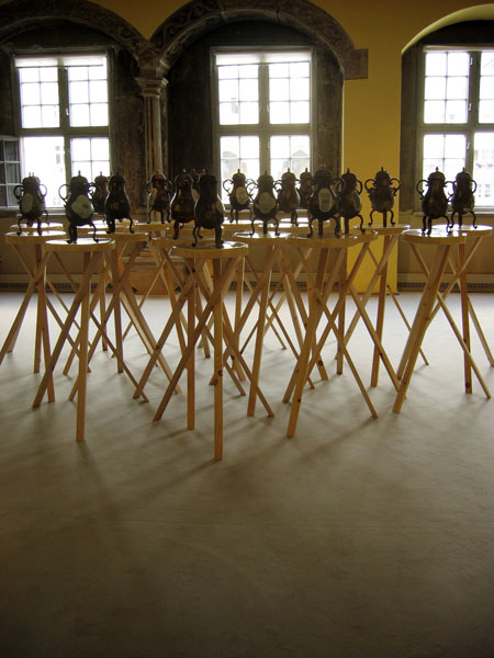 John Armstrong Twenty Glasses of Water: Circle (2002-2003) enamel on bronze, porcelain and wood bronzes 40 x 24 x 16 cm with base 142 x 76 x 76 cm, 20 pieces in total